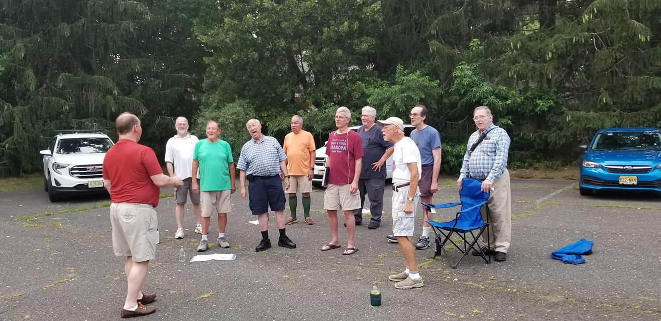 Chorus of the Atlantic rehearsing outdoors at Lincroft Presbyterian Church